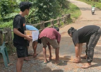 Puluhan Tahun Tak Diperbaiki, Pemuda Cibitung Kompak Tambal Jembatan yang Bolong